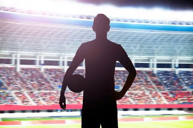 0_Silhouette-of-soccer-player-standing-in-stadium-with-a-ball.jpg